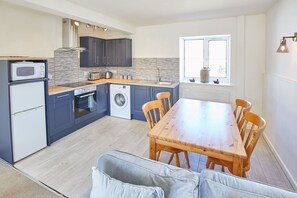 Enjoy meals in the kitchen with a central island, sink, microwave, and toaster, and dine in the adjacent seating area.