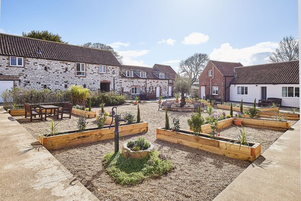Guests can dine al fresco in this charming courtyard, surrounded by lush greenery and traditional architecture.