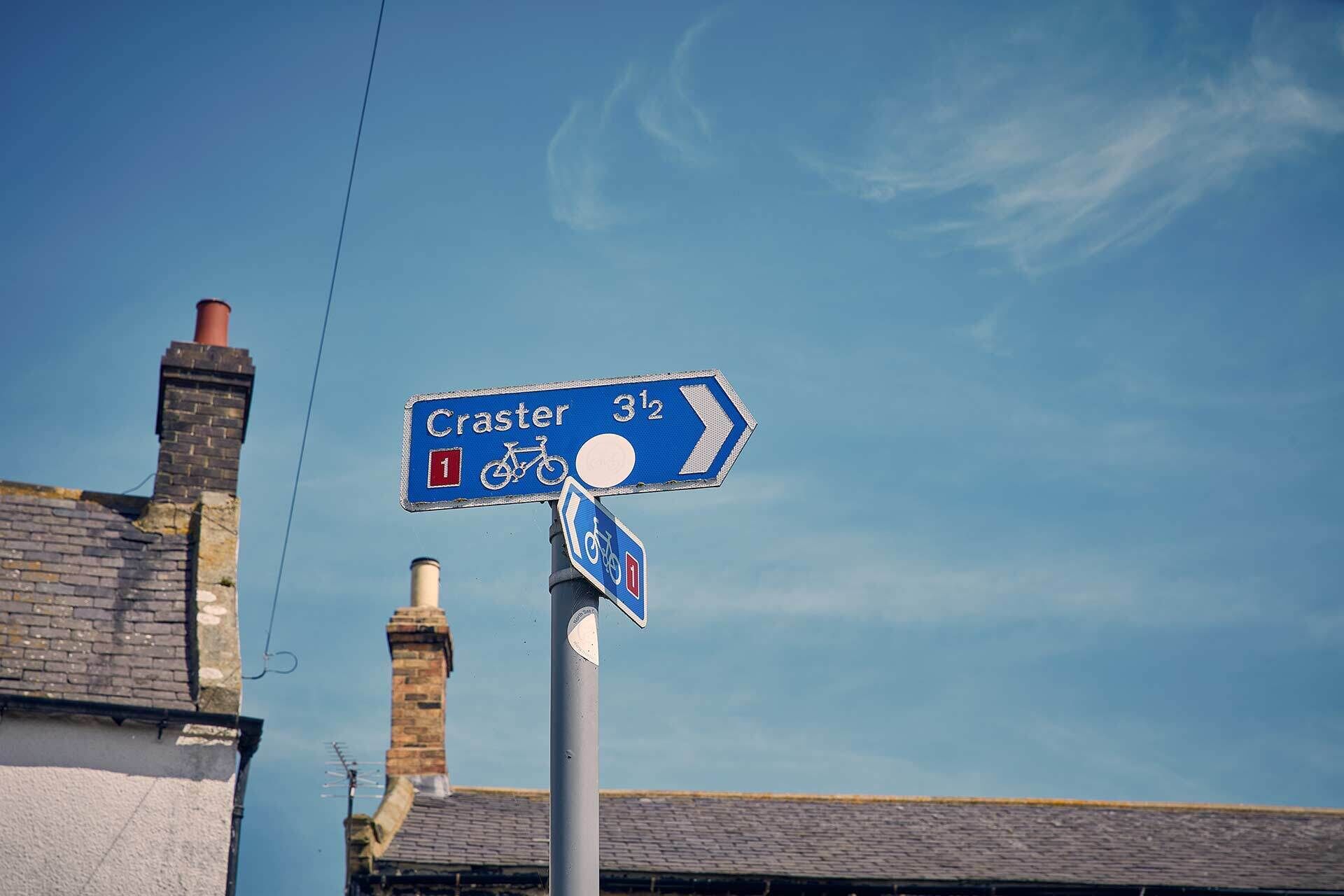 A directional sign for Craster, indicating a distance of 3 1/2 miles.