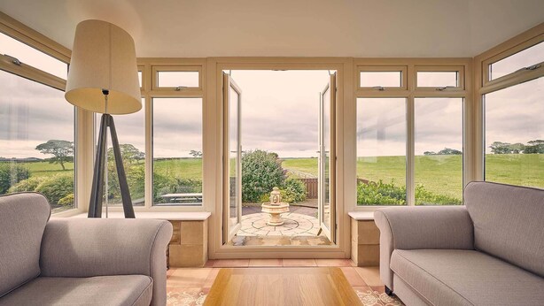 A room with a large window, a floor lamp, and two sofas. - Host Stay Cheviot View (Seahouses)
