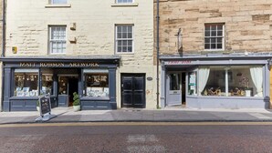 A street view with two storefronts: 'Matt Robson Artwork' and 'Thai Dibe'. - Host Stay The Burrow (Alnwick)