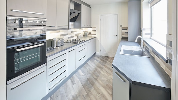 A modern kitchen with a built-in oven, a toaster, and a sink. - Host Stay 1 Montrose Street (Saltburn-by-the-Sea)