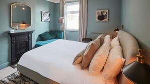 A bedroom with a large bed, a dresser, a mirror, and a window with curtains. - Host Stay The Railman s House (York)