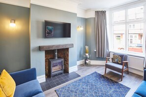 Cozy seating area with a fireplace and city view.