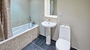 A bathroom with a bathtub, sink, and toilet. - Host Stay Three Bays (Scarborough)