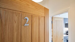 A wooden door with the number 2 on it, indicating a room number. - Host Stay Apartment 2 Queens Court (Scarborough)