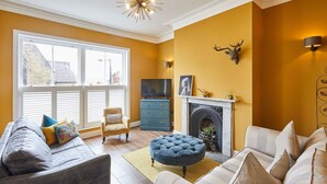A living room with a fireplace, a television, and a sofa. - Host Stay One Mulgrave Place (Whitby)