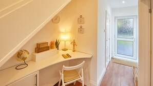 A cozy study area with a desk, chair, globe, lamp, and framed pictures on the wall. - Host Stay Newsam Crescent (Stockton-on-Tees)