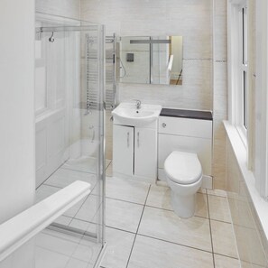 A modern bathroom with a glass shower enclosure, a white sink, and a toilet. - Host Stay Victorian Seahouse (Saltburn-by-the-Sea)