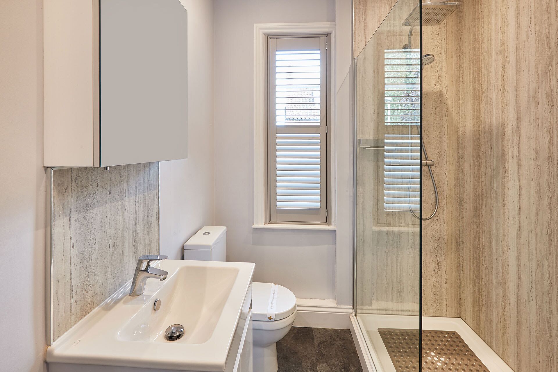 A bathroom with a sink, toilet, and shower.