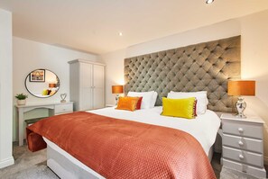 Relax in comfort with a spacious bed, a stylish desk, and ample storage.