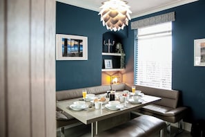Enjoy breakfast at the central table in this stylish dining area, complete with a chandelier and framed artwork.
