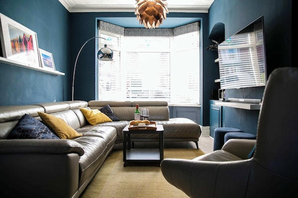 Relax in this stylish living room with a leather sofa, coffee table, and comfortable armchair.