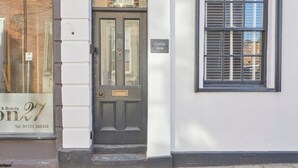 A building with a dark door, a sign reading "Castle View," and a window with blinds. - Host Stay Castle View (Scarborough)