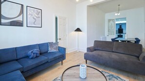 A modern living room with two sofas, a coffee table, and artwork on the walls. - Host Stay Castle View (Scarborough)
