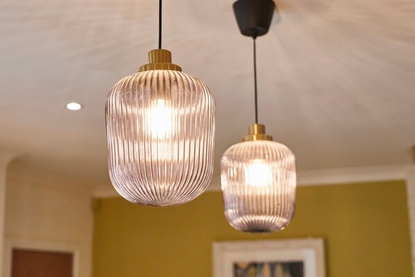 Two pendant lights with ribbed glass shades hanging from the ceiling.