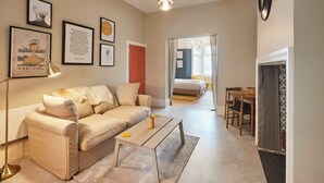 A modern living room with a sofa, coffee table, and framed artwork on the wall. - Host Stay Northville Arrifana (Whitley Bay)