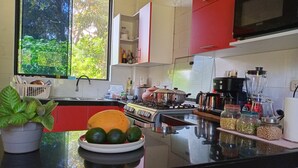 A modern kitchen with a stove, sink, and various appliances.