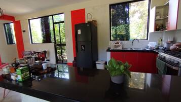 Full-sized fridge, microwave, cookware/dishes/utensils