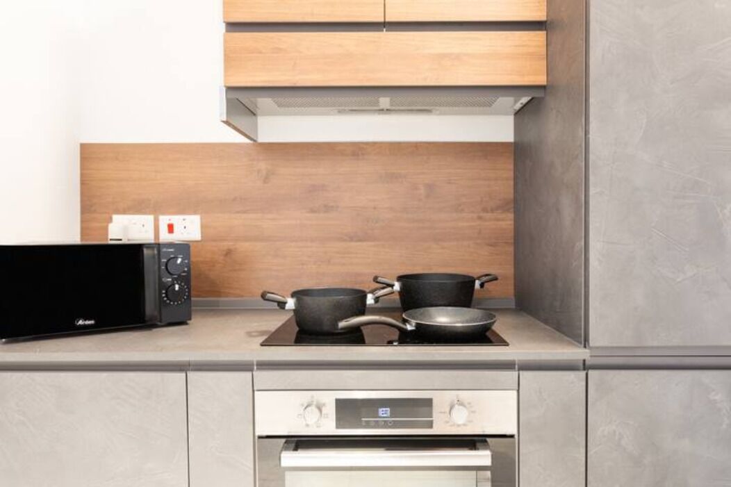 A kitchen with a microwave, stove, and oven.