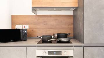 A kitchen with a microwave, stove, and oven.