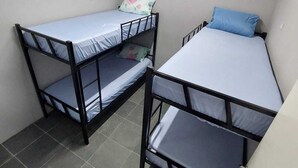 A small, compact room with two bunk beds, each with a mattress and pillow. - Hostel Vila Brás  (São Paulo)