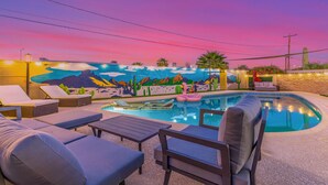 A pool area with lounge chairs and a mural on the wall. - The Rody - Mins to Old Town with Heated Pool, Games, Fast Wifi and More... (Scottsdale)