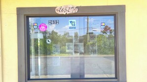A window with a number "2632" and various stickers, including a "VISA" logo. - Relax Inn By OYO Sulphur Hwy 90 (Sulphur)