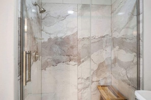 Bathtub, hair dryer, towels, shampoo