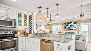 A modern kitchen with white cabinetry, a built-in oven, and a dishwasher.