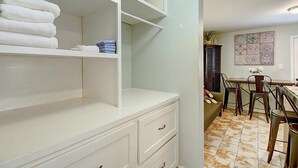 A bathroom with white cabinetry, a sink, and a tiled floor. - Kona Cottage~Dog Friendly~In Town Location (Port Aransas)