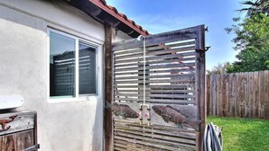 A wooden gate with a metal handle and a small window to the left.