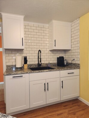 Fridge, coffee/tea maker, toaster, cookware/dishes/utensils