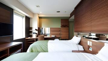 A hotel room with two beds, a TV, a desk, and a bathroom.