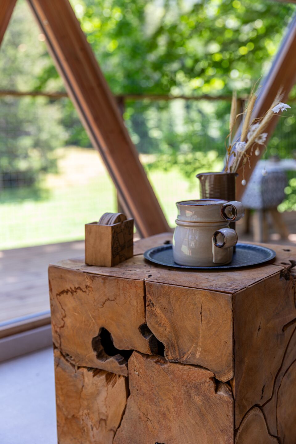 A rustic wooden table with a ceramic pot and a small wooden box.