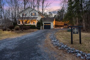 A house with a garage, a driveway, and a sign labeled 'The Reserve.'