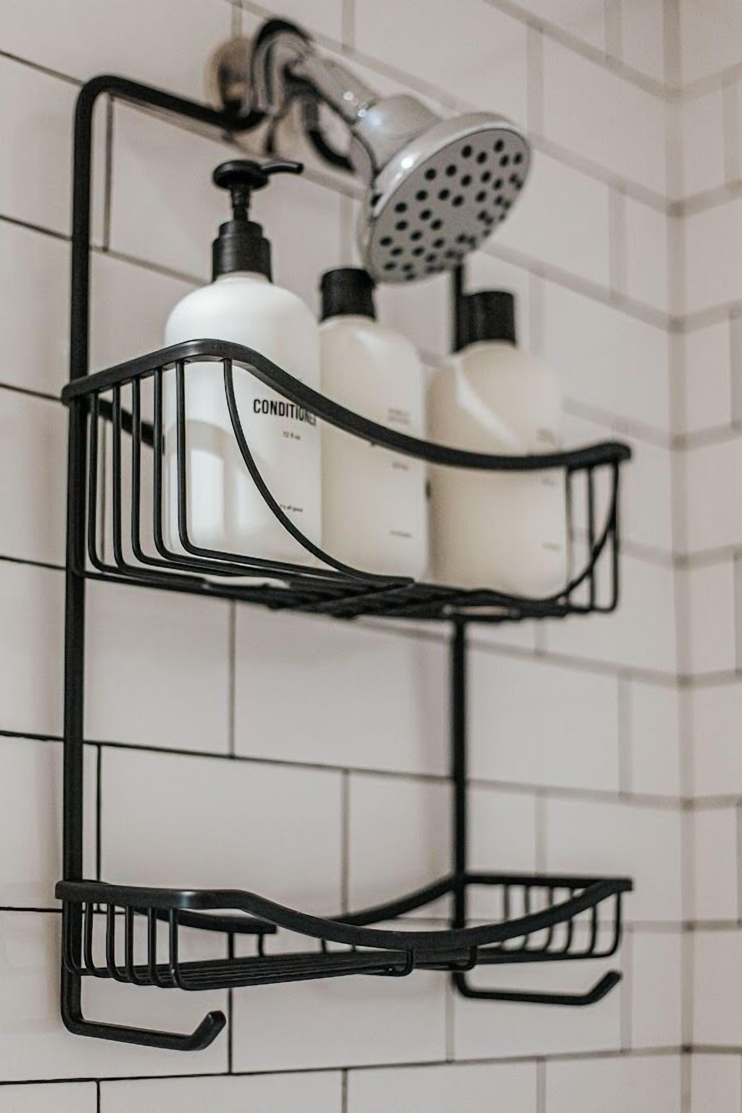 A black metal shelf unit with multiple compartments, including a hanging showerhead and bottles of toiletries.
