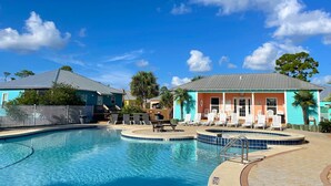 A pool area with lounge chairs and a small pool. -  PARADISE PALMS 6016 at Rookery III - Walk to Beach - Relax by Pools (Gulf Shores)