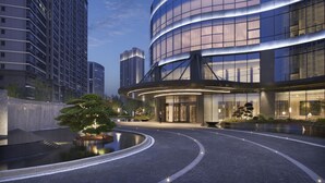 A modern hotel with a curved glass facade, a landscaped garden with a pond, and a well-lit entrance. - Hyatt Regency Changshu Kuncheng Lake (Suzhou)