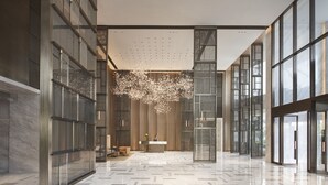 A spacious lobby with a marble floor, large glass panels, and a central chandelier. - Hyatt Regency Changshu Kuncheng Lake (Suzhou)