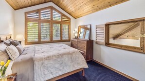 A bedroom with a large window, a bed, a dresser, and a mirror. - 2BR ski-in/out condo in Beaver Creek Village with valley views. (Beaver Creek)