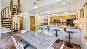 A modern kitchen with wooden cabinets, a central island, and a built-in refrigerator. - Ski In/out with HOT TUB! PENTHOUSE, Walk to Ski School & Restaurants! BC Village (Beaver Creek)