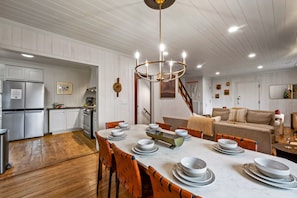Enjoy meals together at the spacious dining table, surrounded by comfortable seating and stylish decor.