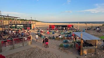 A beachside market with stalls and seating areas.
