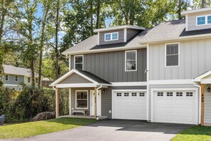 A two-story house with a garage, a covered porch, and a small front yard. - Little Sycamore by Avantstay Premier Location + Patio (Asheville)