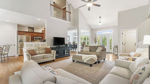 A spacious living room with a high ceiling, a television, and a dining area in the background. - Fairview Vista by Avantstay 10 Mins to Asheville (Fairview)