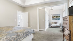 A bedroom with a bed, a dresser, a chair, and a door leading to another room. - Fairview Vista by Avantstay 10 Mins to Asheville (Fairview)