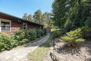 Surrounded by lush greenery, this cabin offers a serene natural setting.