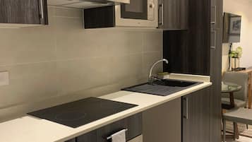 Mini-fridge, microwave, oven, stovetop