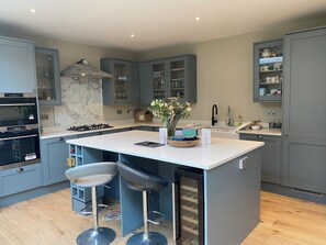 Enjoy cooking in this well-equipped kitchen with a central island and appliances.